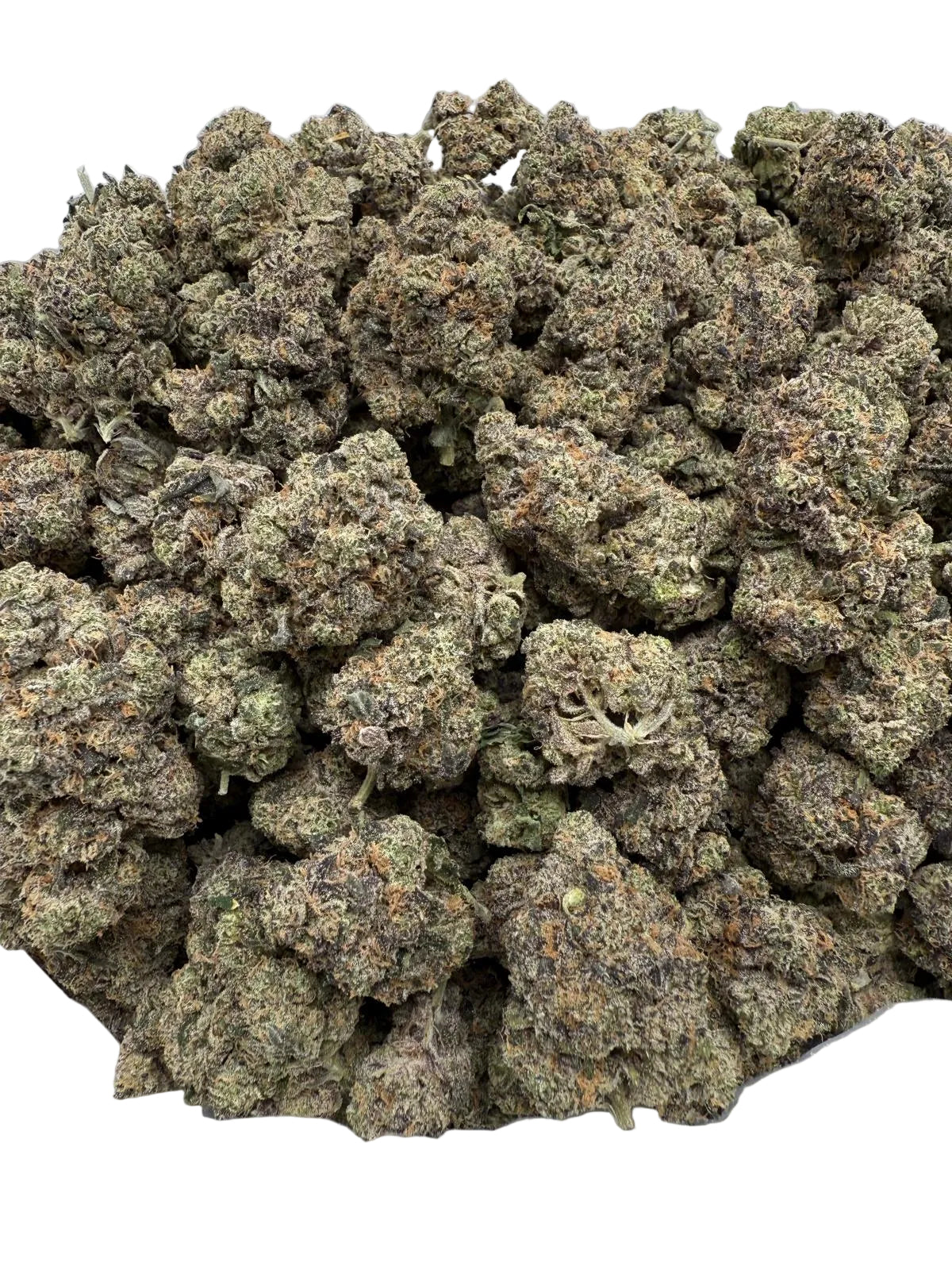 Close-up of a pile of dried cannabis buds on a clear plastic surface.