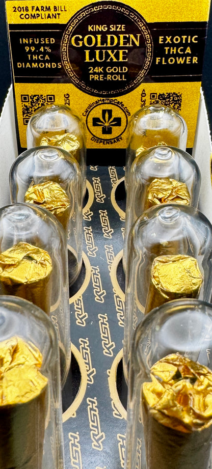 Gold pre-rolls in a clear tubes with a yellow label on a white background.  Display box with 8 of them