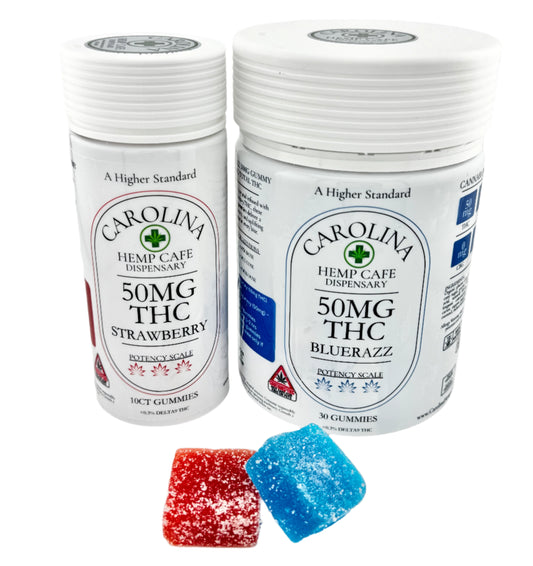 Two bottles of Carolina Hemp Cafe's 50mg Delta 9 THC gummies, one labeled strawberry and one labeled blue raz, with childproof containers and gummy candies displayed in front.