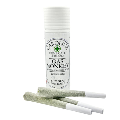 White cylinder Jar by Carolina Hemp Cafe with 3 pre-rolls laying in front of it.  Label says Gas Monkey