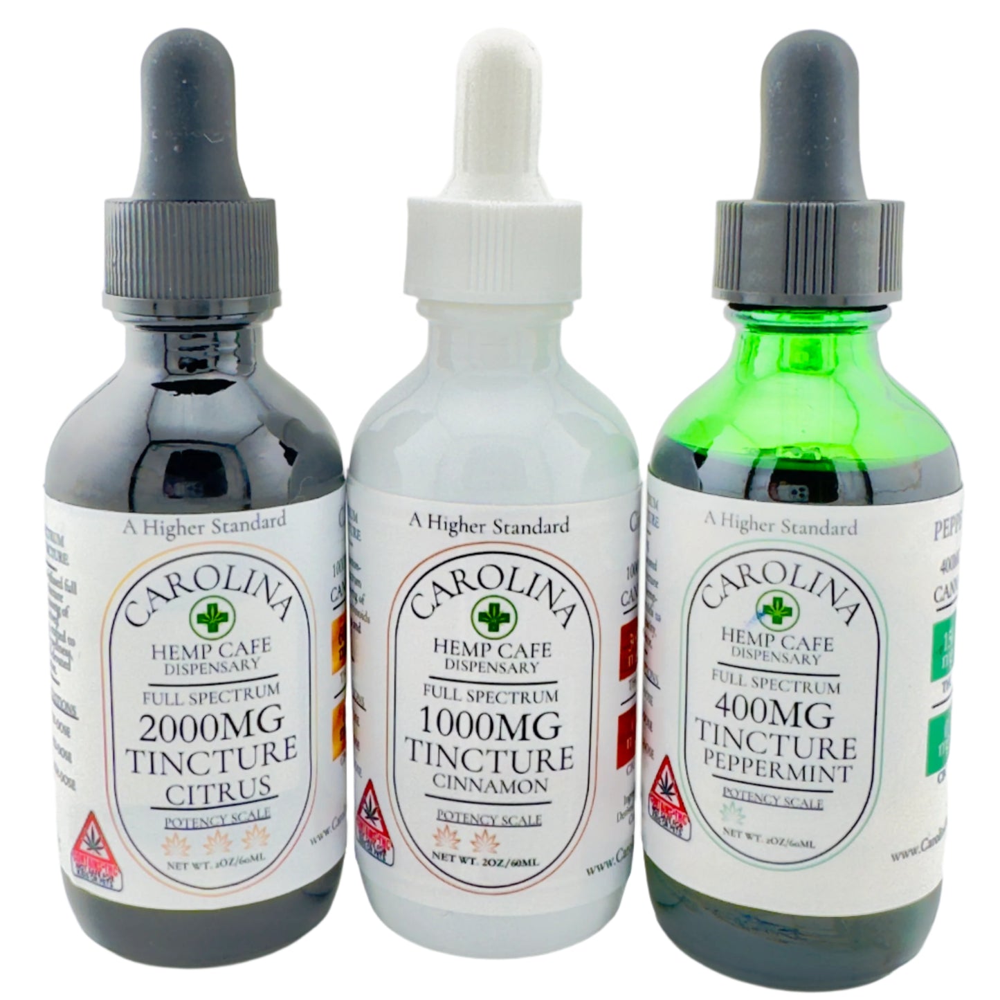 Three bottles of Carolina Hemp Cafe's Full Spectrum THC:CBD Tinctures in different potencies, with dropper caps. The potencies are 400mg Peppermint, 1000mg Cinnamon, and 2000mg Citrus, labeled in white and green packaging.