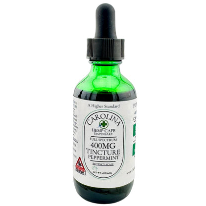 Three bottles of Carolina Hemp Cafe's Full Spectrum THC:CBD Tinctures in different potencies, with dropper caps. The potencies are 400mg Peppermint, 1000mg Cinnamon, and 2000mg Citrus, labeled in white and green packaging.
