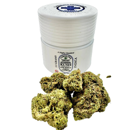 White container with cannabis buds on a light gray background