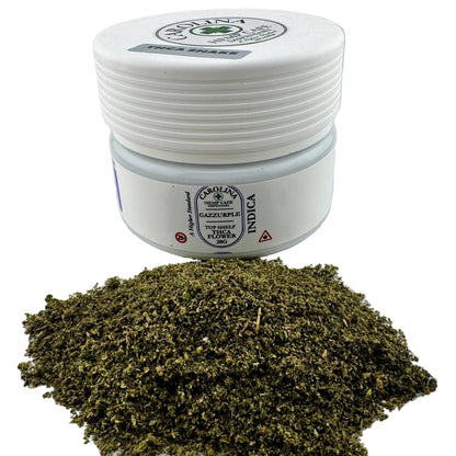 Jar of cannabis flower with a white lid on a light gray background