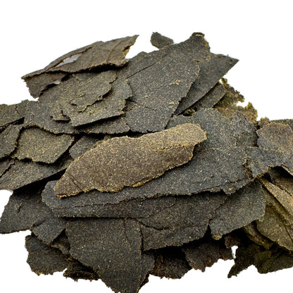 Stack of dark green seaweed sheets on a white background