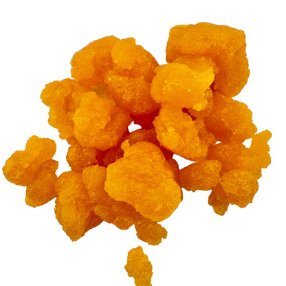Cluster of orange-yellow gummy bears on a white background