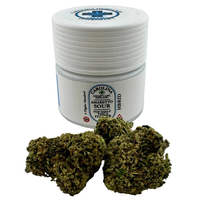 White container labeled 'Carolina Hemp' with cannabis buds on a light background