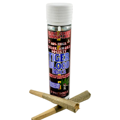 Bottle of 'Tiger Blood Indica' pre-rolled joints with rolling papers on a gray background