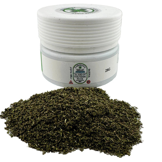 White container with green label on a white background, surrounded by green powder.