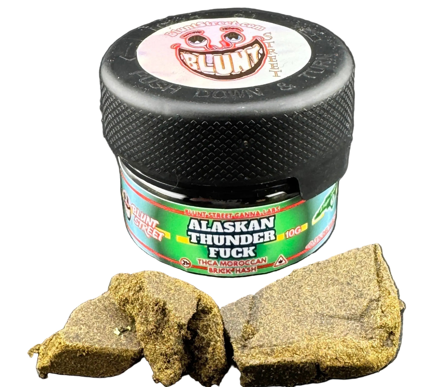 Jar of 'Alaskan Thunder F**ck' with cannabis buds on a gray surface