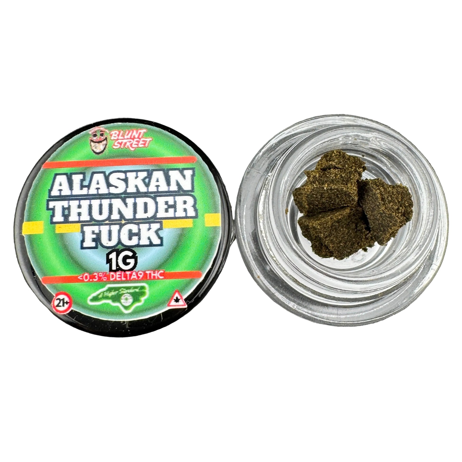 Jar of cannabis buds next to a container labeled 'Alaskan Thunder Fuck' on a gray background
