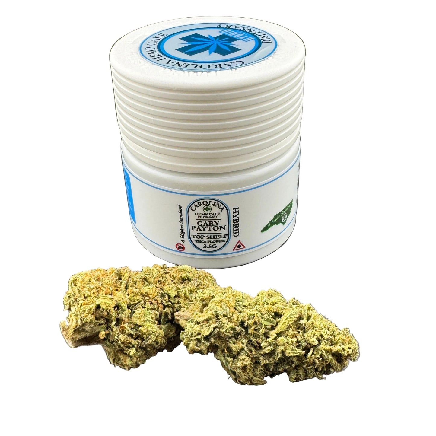 Stack of white containers with blue labels and a clump of green cannabis on a dark surface.