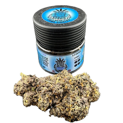 Jar of cannabis buds with a label on a dark surface