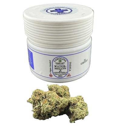 White container with blue label and cannabis buds on a dark surface