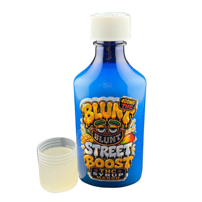 A blue bottle of Blunt Street Boost 40mg THC sugar syrup mango flavor, shown with its white cap off and a small clear plastic cup containing a pale yellow liquid, set against a dark gray background.