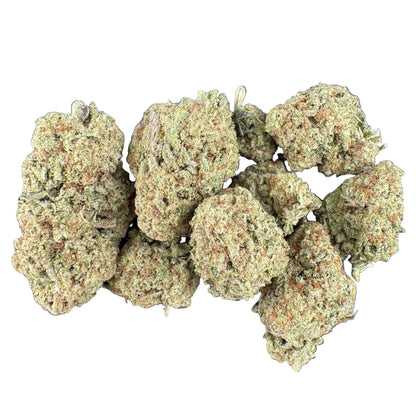 A cluster of dried cannabis buds in shades of green and brown, arranged on a dark gray textured surface.
