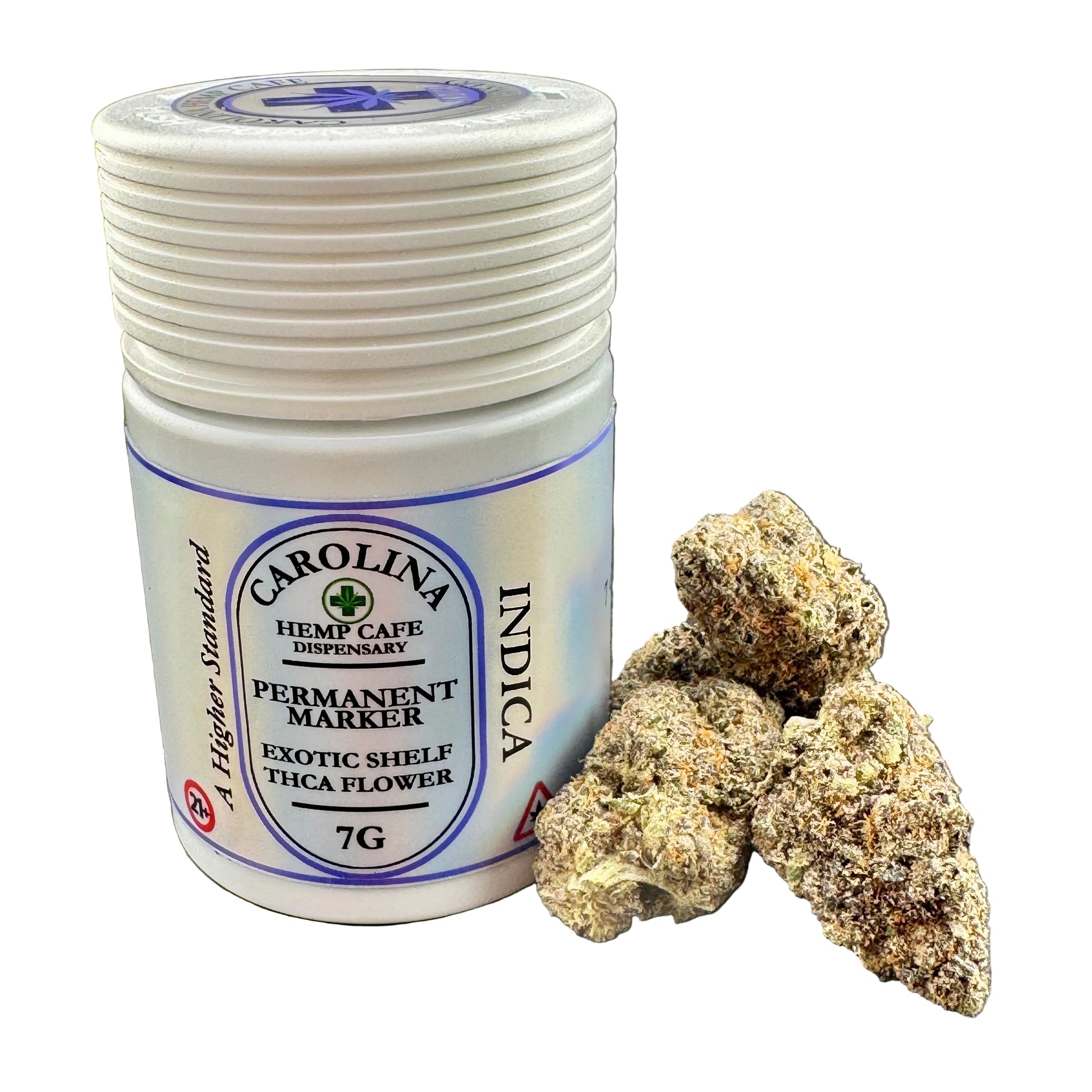 A white plastic jar of Carolina Indica Exotic Shelf THCA Flower with a blue and white label, shown next to several dried, textured flower buds on a dark gray background.