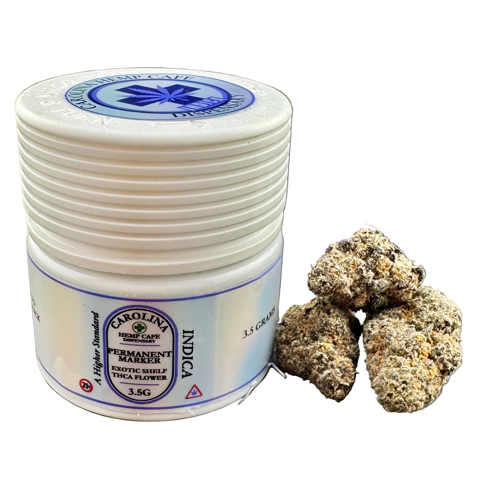 A white plastic jar of Carolina Exotic Shelf Indica permanent marker with a blue and white label, shown next to several dried cannabis buds on a dark gray background.