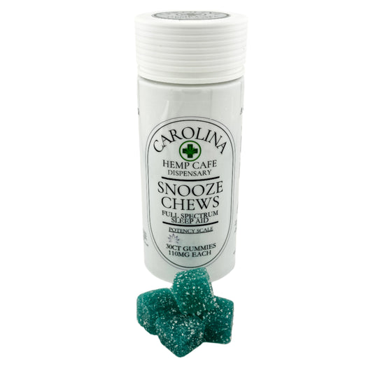 A bottle of Carolina Hemp Cafe's Snooze Chews, Full Spectrum Sleep Aid, with a couple of blue gummy chews displayed in front.