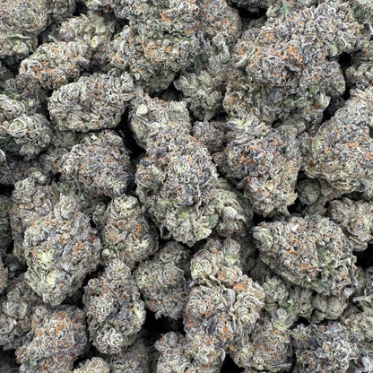 Close-up of a pile of cannabis buds with a white background