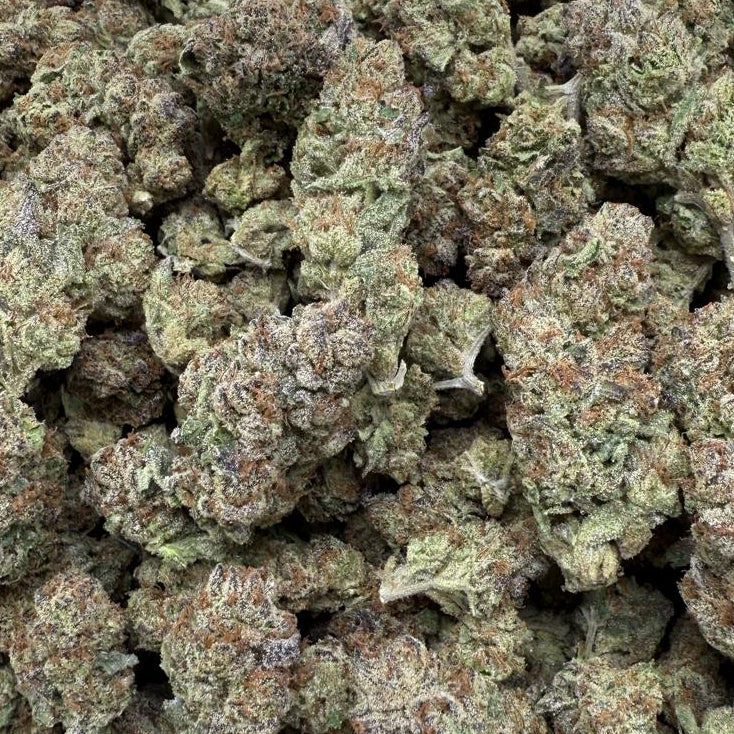 Close-up of dried cannabis buds on a gray surface