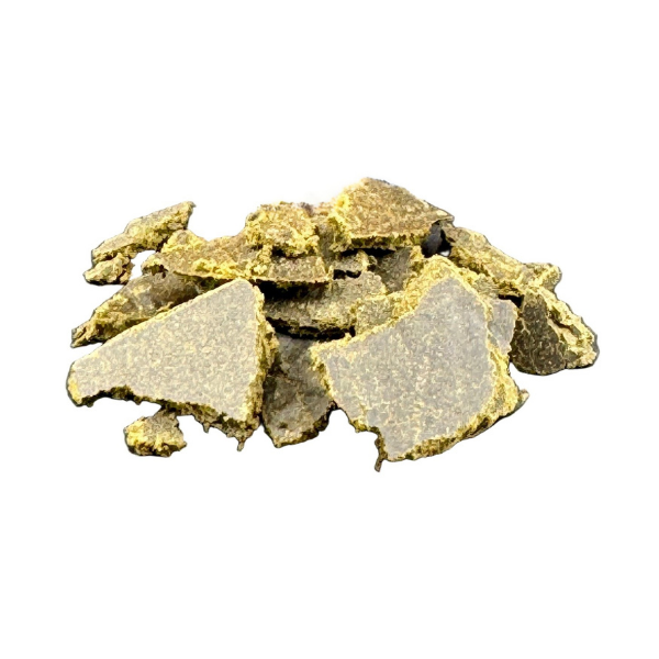 Pile of gold-colored crystals on a white background